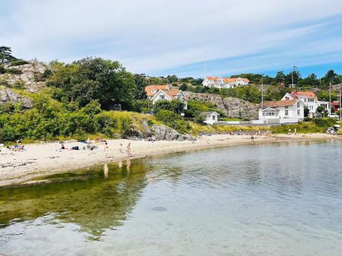a group of people on a beach near the water at 4 person holiday home in Rönnäng-By Traum in Rönnäng