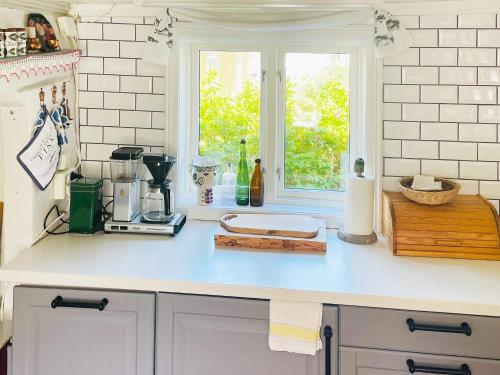 a kitchen with a counter top with a window at 4 person holiday home in Rönnäng-By Traum in Rönnäng