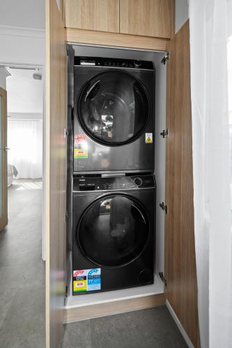 a washer and dryer inside of a closet at Studio Four 