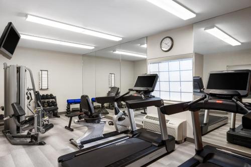 a gym with treadmills and cardio equipment and a clock at Candlewood Suites Yuma by IHG in Yuma