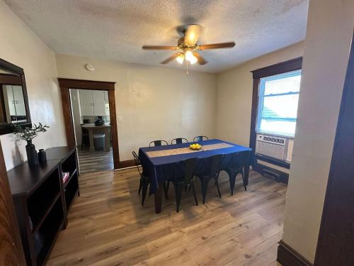 a dining room with a blue table and chairs at Charming 4BR Westside Home in Beer City USA in Grand Rapids