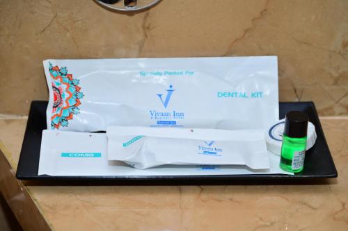 a box of toilet paper and a bottle of mouthwash at Vivaan Inn in Vijayawāda