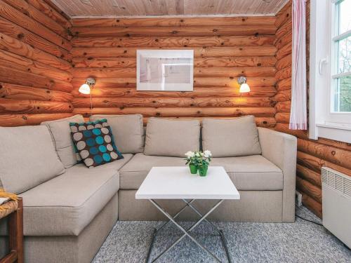a living room with a couch and a table at 6 person holiday home in Hovborg in Hovborg