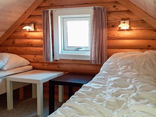 a bedroom with a bed and a window in a cabin at 6 person holiday home in Hovborg in Hovborg
