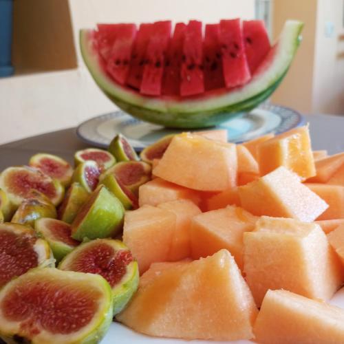 a plate of cut up fruit with a watermelon at B&B Villa Maurizio in Tskaltubo