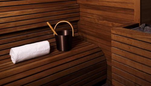 a sauna with a roll of toilet paper and a bucket at Rosewood Vienna in Vienna