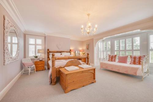 a bedroom with a bed and a couch and a table at Church Beck House in Scalby