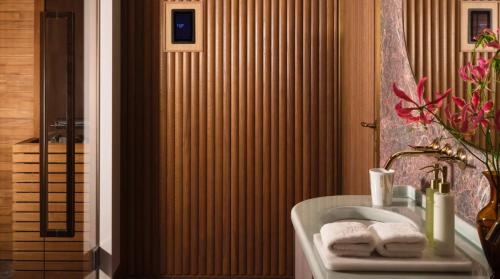 a bathroom with a tub and a sink with towels at Rosewood Vienna in Vienna