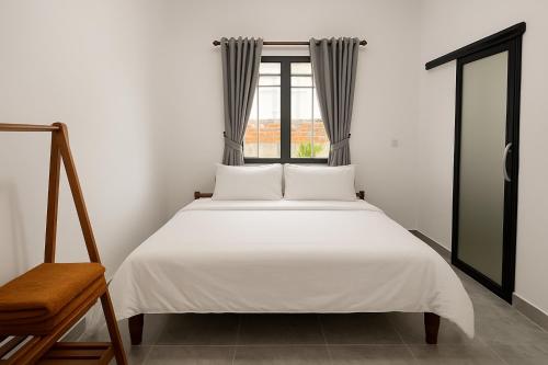 Ένα ή περισσότερα κρεβάτια σε δωμάτιο στο Kampot Vacation Home
