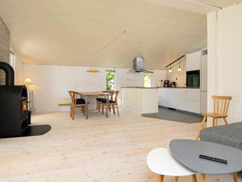 a kitchen and living room with a table and chairs at 8 person holiday home in Hals in Hals