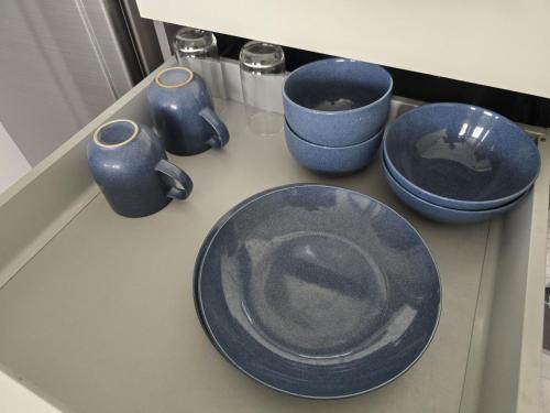 a counter with blue bowls and plates on it at Seabreeze Suite 1-Bed T3-637 in Phuket