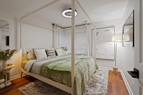 a bedroom with a canopy bed and a rug at Stylish Evanston Retreat Near NU & Lakefront in Evanston