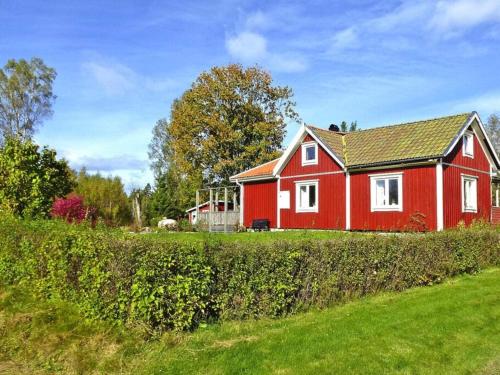 a red house in the middle of a field at 4 person holiday home in Brålanda-By Traum in Brålanda