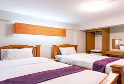 a hotel room with two beds in it at xx GO INN Khaosan Road Bangkok - โก อินน์ ถนนข้าวสาร in Bangkok
