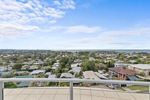 a view of a city from the balcony of a house at Beachside Penthouse w Private Rooftop & Oceanviews in Caloundra