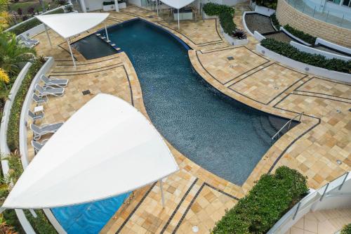 an overhead view of a swimming pool in a building at Beachside Penthouse w Private Rooftop & Oceanviews in Caloundra