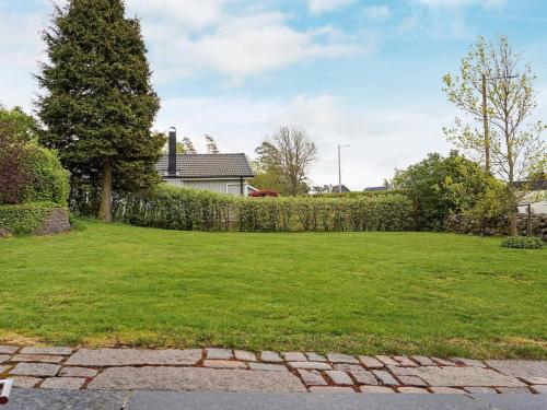 a yard with a fence and green grass at 3 person holiday home in ONSALA in Onsala