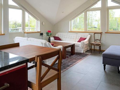 a living room with white furniture and windows at 3 person holiday home in ONSALA in Onsala
