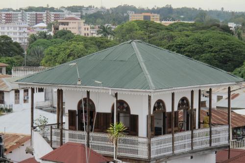 a large white building with a green roof at Zanzibar Coffee House in Zanzibar City