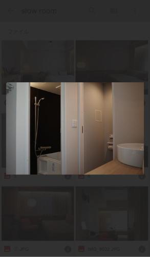 a view of a bathroom with a tub and a sink at etoe Hotel Shinjuku in Tokyo