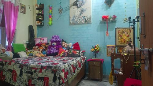 a bedroom with a bed with stuffed animals on it at Apno Ka Aangan in Haridwār