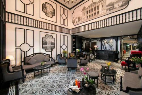 Un vestíbulo con sofás y mesas en un edificio. en Hanoi Le Chateau Hotel & Spa, en Hanói
