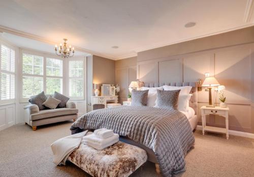 a large bedroom with a large bed and a couch at Church Beck Retreat in Scalby
