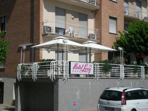 a sign on the side of a building with an umbrella at Hotel Lory My Wellness SPA in Chianciano Terme