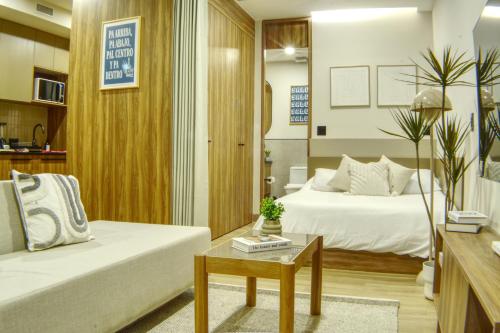 a living room with a bed and a couch at Expo GDL 2 Min Executive Style and Comfort in Guadalajara