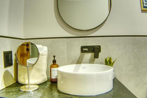 a bathroom counter with a sink and a mirror at Expo GDL 2 Min Executive Style and Comfort in Guadalajara