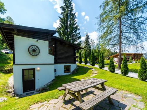 a picnic table in front of a small building at Chalet in Wörgl near Ski Lift in Hopfgarten im Brixental
