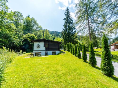 a small cabin in the middle of a grassy yard at Chalet in Wörgl near Ski Lift in Hopfgarten im Brixental