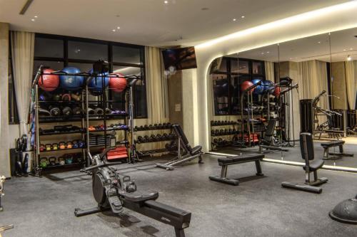 a gym with several treadmills and equipment in a room at Expo GDL 2 Min Executive Style and Comfort in Guadalajara