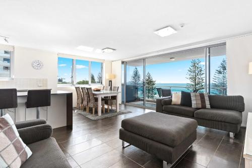 a living room with a view of the ocean at Northwind Beachfront Apartments in Mooloolaba