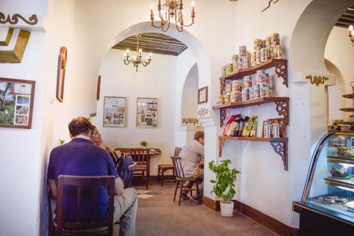 a group of people sitting at a table in a restaurant at Zanzibar Coffee House in Zanzibar City