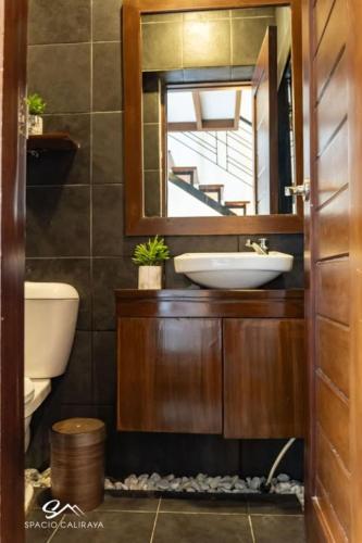 a bathroom with a sink and a mirror at Spacio Caliraya Bed & Breakfast in Lumban