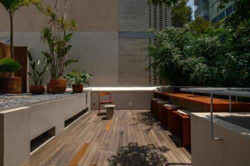 a patio with plants on a building at Cholula Condesa Hotel by Lumina in Mexico City