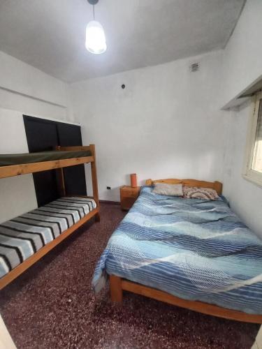 a bedroom with two beds in a room at Alquiler en las Toninas a 2 cuadras del mar in Las Toninas