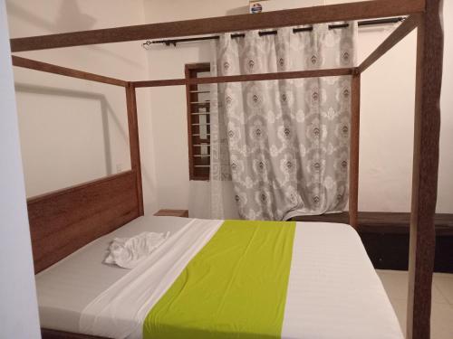 a bedroom with a bed with a yellow and green blanket at Utulivu Bungalow in Nungwi