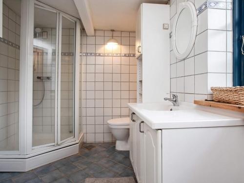 a bathroom with a toilet and a sink and a shower at 5 person holiday home in Bogø By in Bogø By
