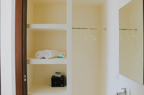 a bathroom with a towel rack and a shower at Ramady Guesthouse in Tumbak Bayuh