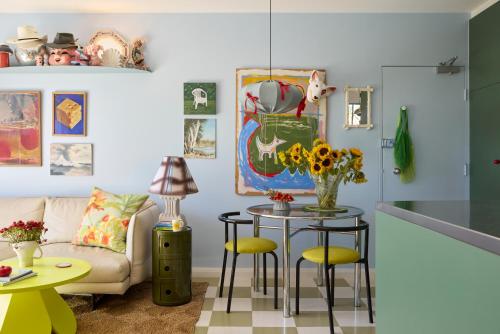 a living room with a table and a couch at Designer Bondi apartment - walk to beach! in Sydney