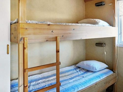 a couple of bunk beds in a room at Seaside Charm in Flaton Retreat-By Traum in Ellos