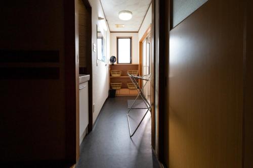 a hallway with a door leading to a kitchen at Fukunosumika - Vacation STAY 80596v in Nanto