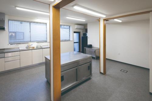 a large kitchen with white cabinets and a counter top at Fukunosumika - Vacation STAY 80596v in Nanto