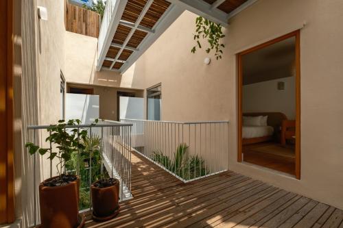 a house with a balcony with plants on it at Cholula Condesa Hotel by Lumina in Mexico City