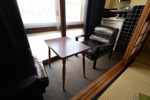 a coffee table and a chair in a room at Fukunosumika - Vacation STAY 80610v in Nanto