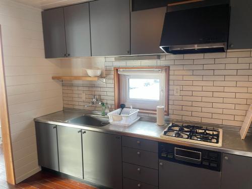 a kitchen with a sink and a stove at Rusutsu Golf&Ski Lodge - Vacation STAY 18170 in Rusutsu