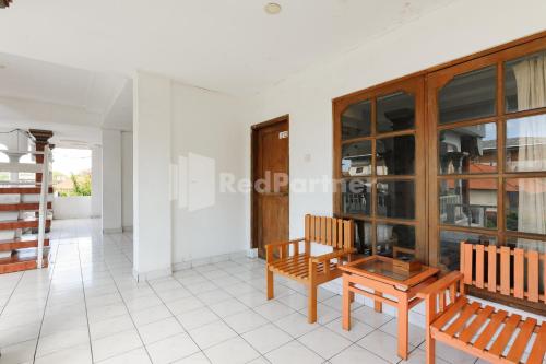 a living room with two chairs and a table at Pulau Bali Hotel Denpasar RedPartner in Denpasar
