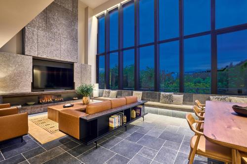 a living room with a couch and a fireplace at Niseko Central Houses and Apartments in Kutchan